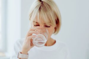 Kobieta pije kolagen na stawy